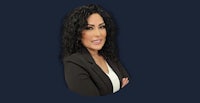 a woman with curly hair is posing with her arms crossed